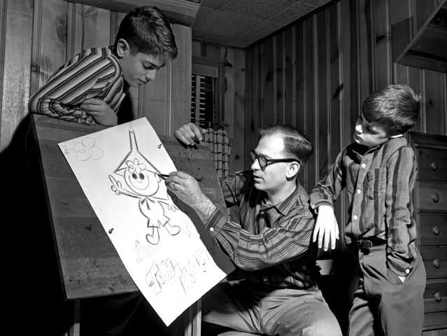 Gene Dietch designing Tom Terrific in front of children. 