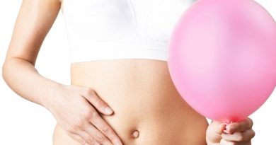 Close Up Of Woman Wearing Underwear Holding Pink Balloon And Touching Stomach