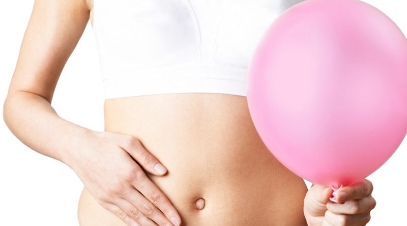 Close Up Of Woman Wearing Underwear Holding Pink Balloon And Touching Stomach