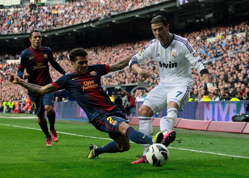 Alves clearing ball off ronaldo's feet