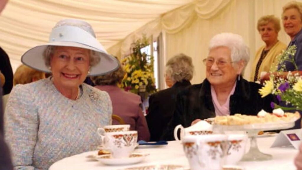 Queen Elizabeth Sitting On Dinning Table